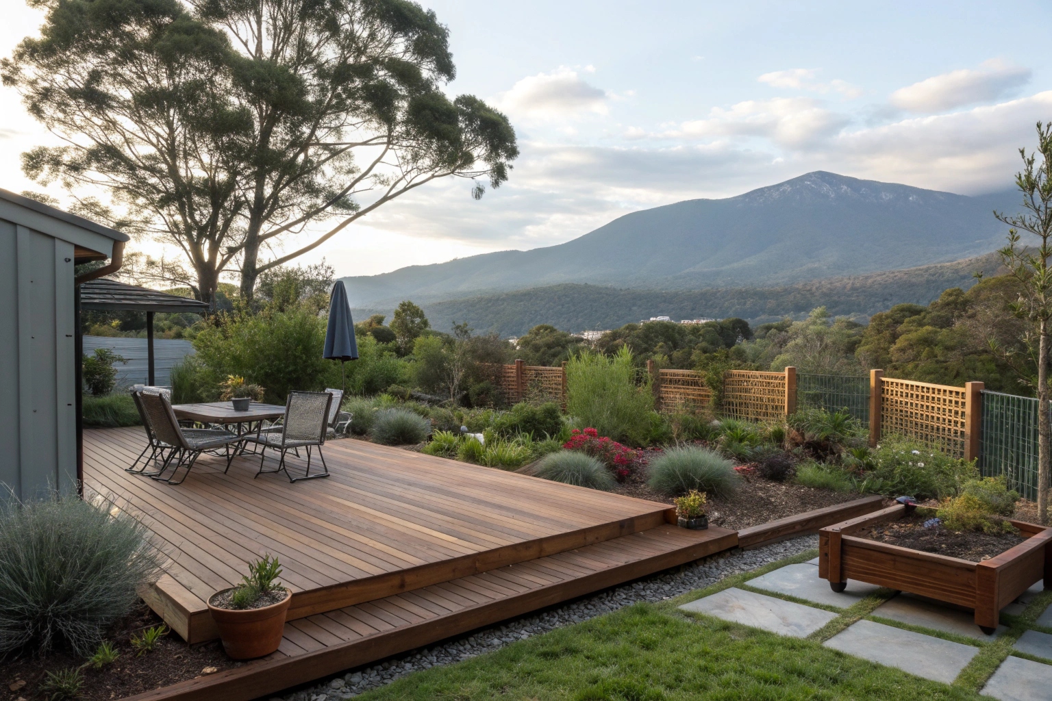 Ground-level timber deck in Hobart backyard with outdoor furniture and mountain views