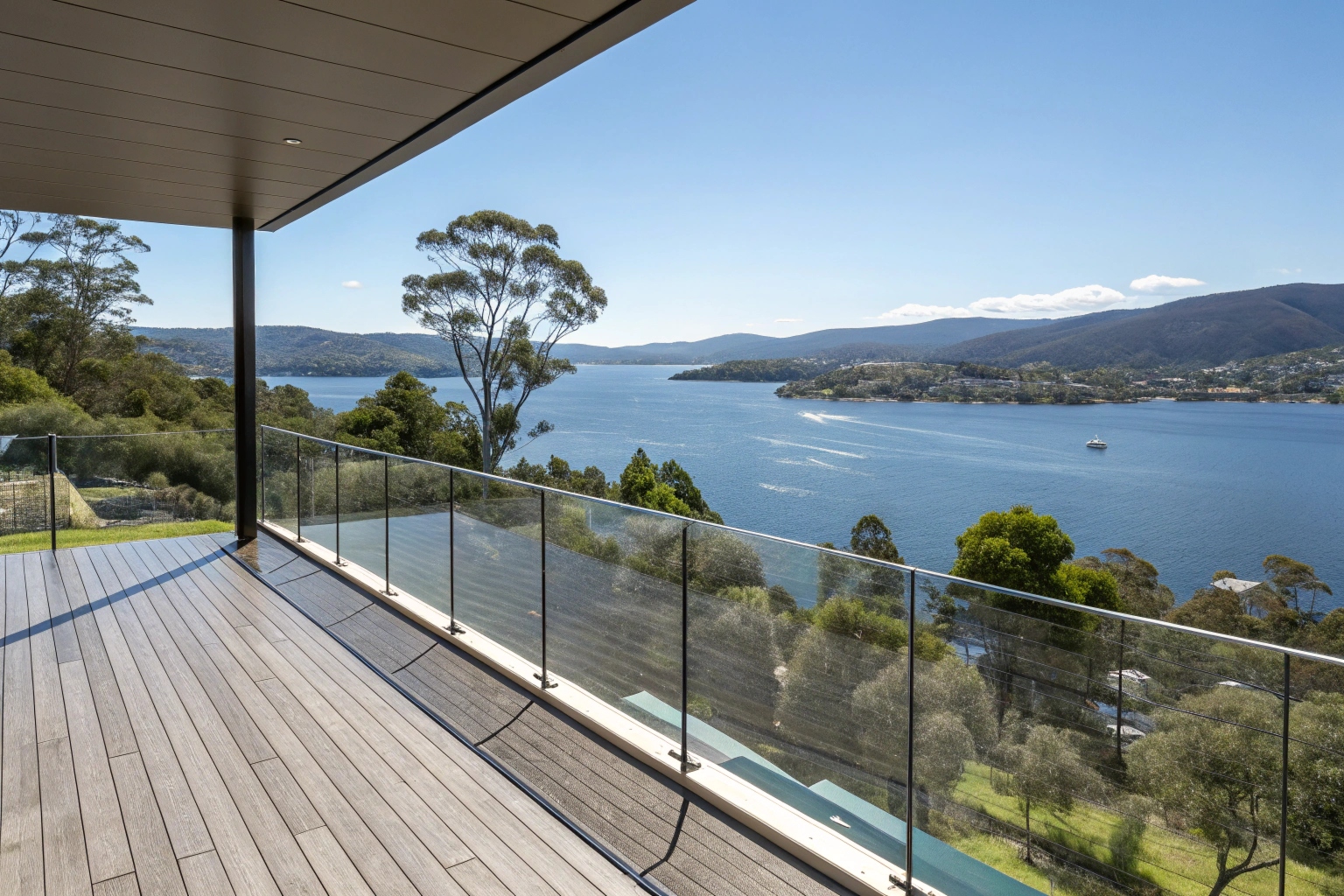 Elevated deck with glass balustrade panels overlooking in Hobart, modern design, water views
