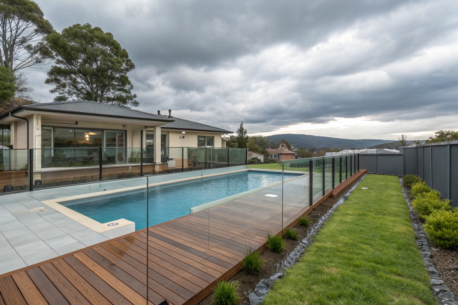 Pool deck with integrated glass safety fence barriers Hobart residential installation